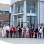 Representatives from the OHFA staff and Board of Trustees are joined by representatives from ADG Blatt and FlintCo in cutting the ribbon on OHFA's remodeled building at 100 N.W. 63rd Street.
