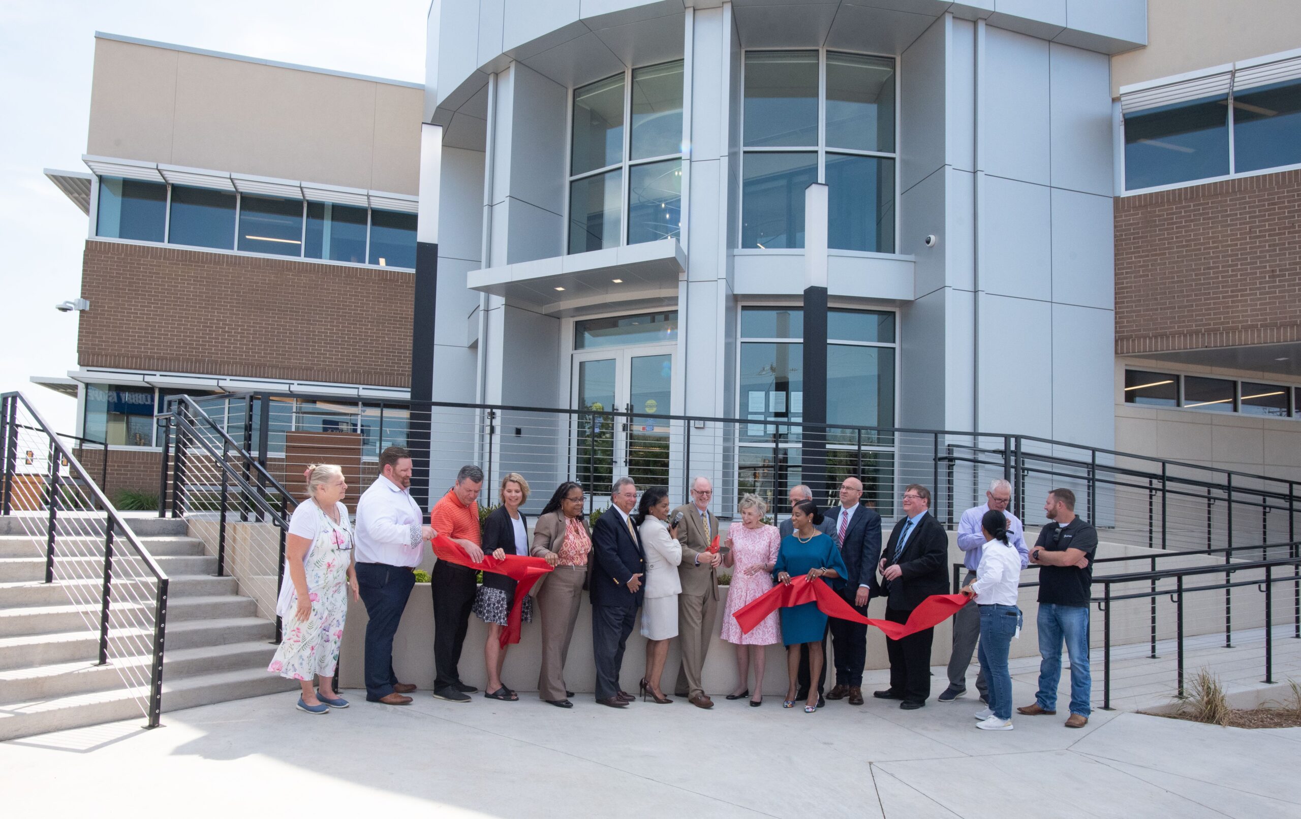 Representatives from the OHFA staff and Board of Trustees are joined by representatives from ADG Blatt and FlintCo in cutting the ribbon on OHFA's remodeled building at 100 N.W. 63rd Street.