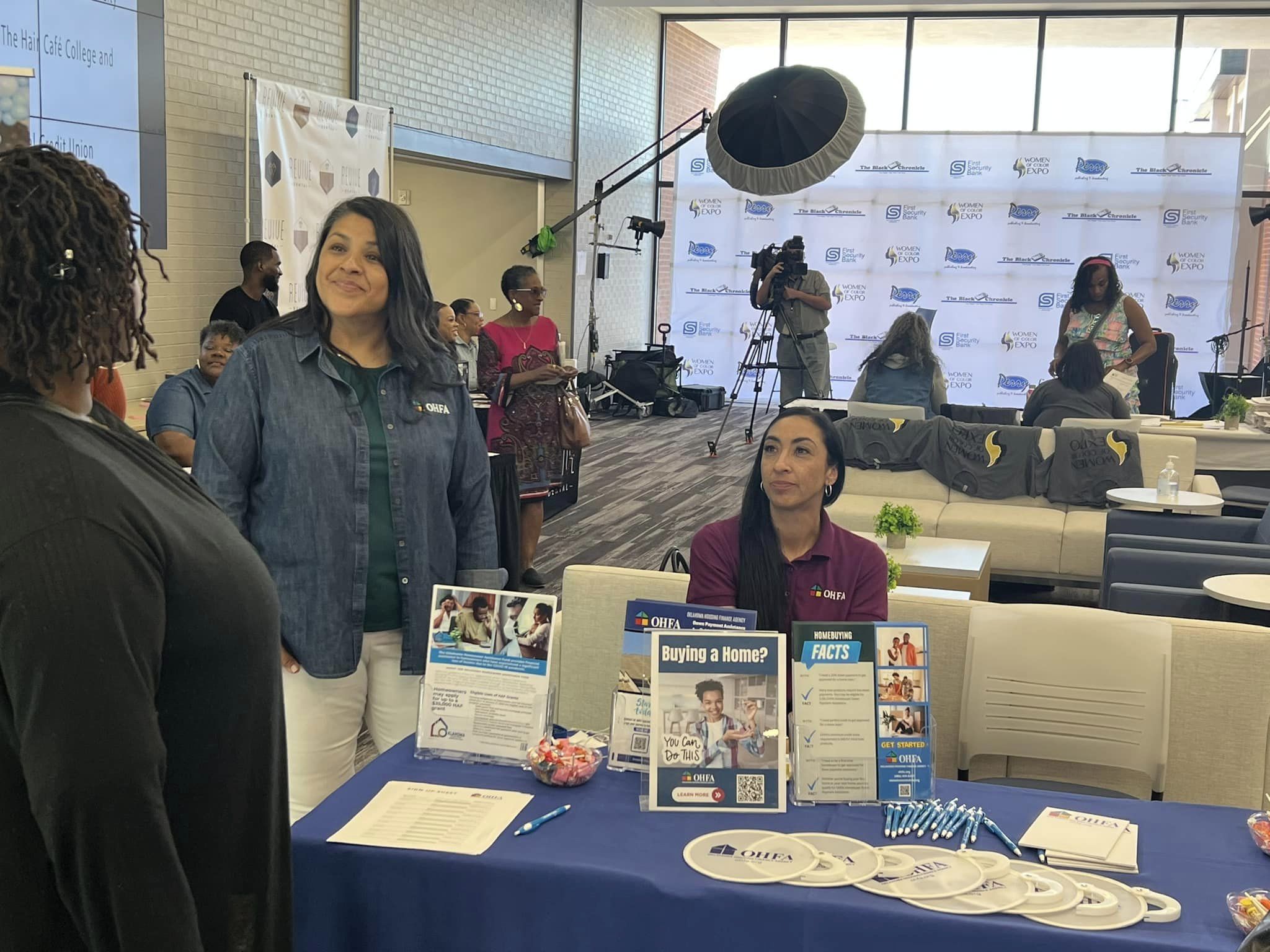 Homeowner Assistance Fund representatives Rosa and Hally visit with attendees at the Women of Color Expo.