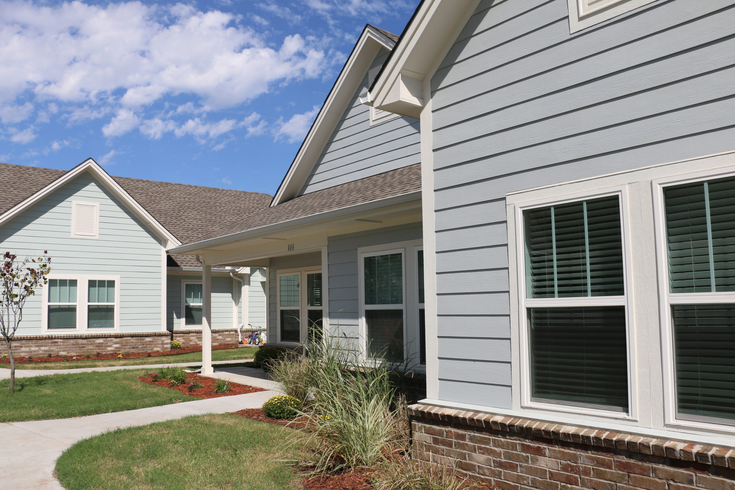 Light blue duplexes at Remerge on a bright blue sky background