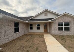 The exterior view of a brick home built by LIFT Community Action Agency in Hugo.