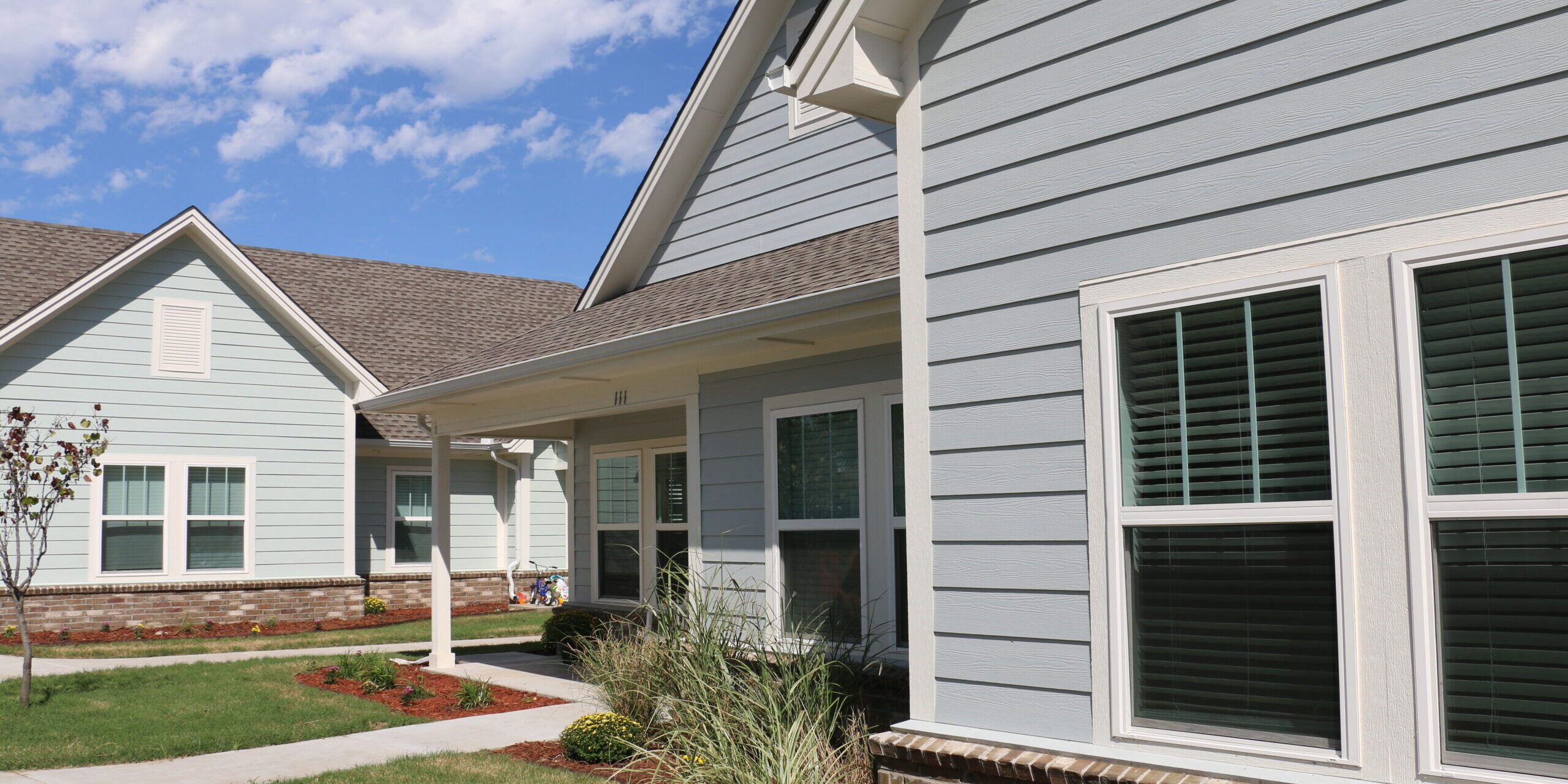 Light blue duplexes at Remerge on a bright blue sky background